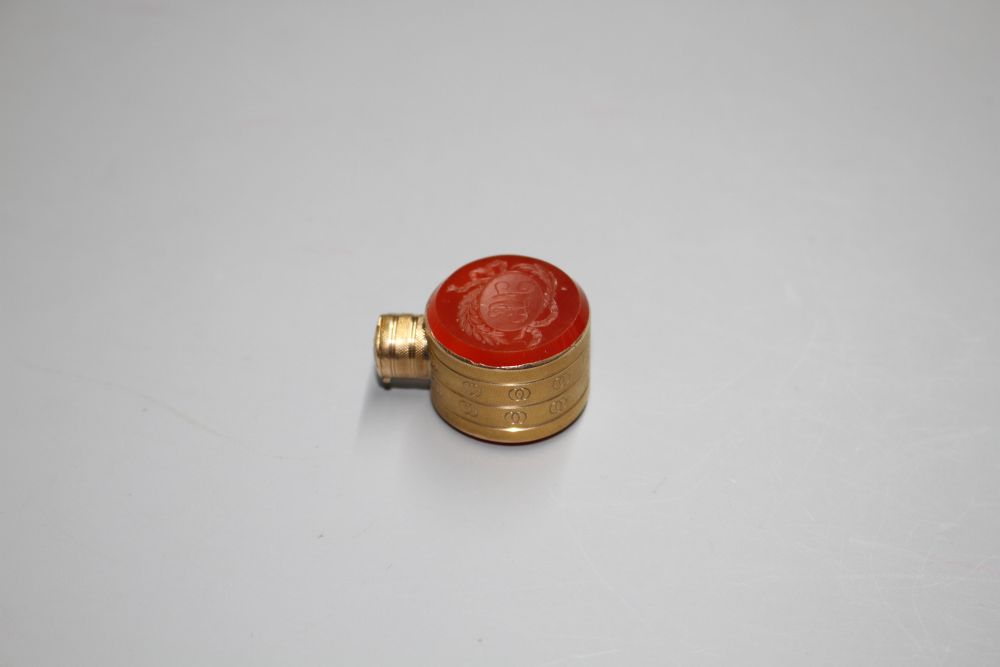 A small 19th century engraved gold and carnelian set moon shaped scent flask,